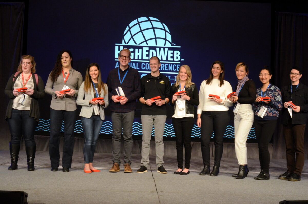 group of HighEdWeb Annual Conference presenters with red staplers