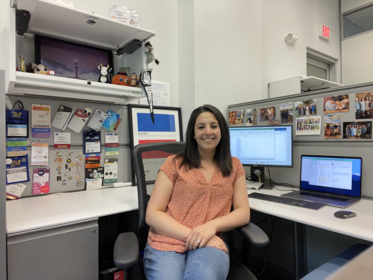 jackie vetrano in her office space, a decorated cubicle with lots of personal items