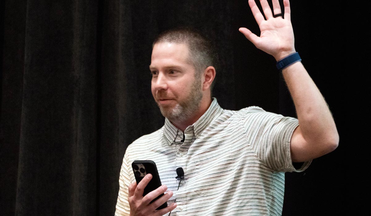 Kris Hardy raises a hand as he presents at the 2025 Digital Collegium Annual Conference