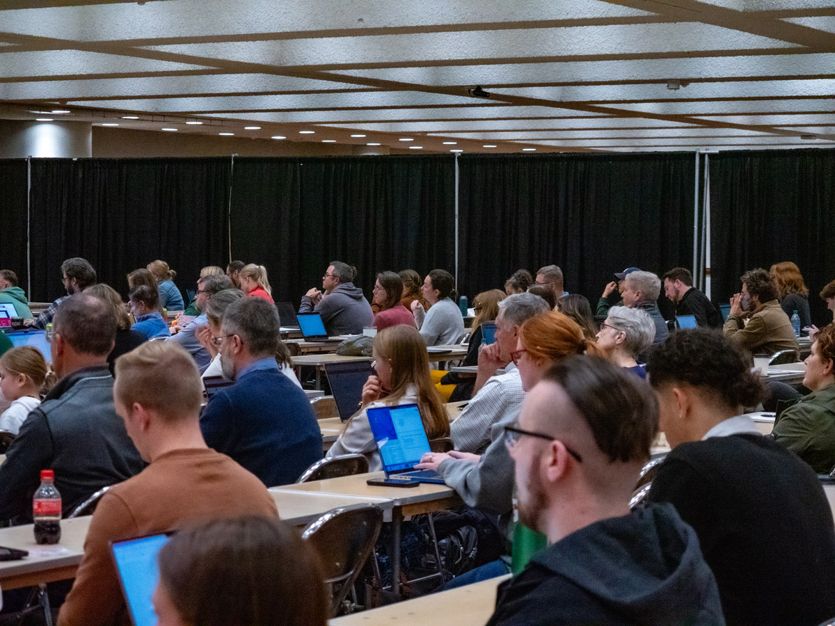 Attendees at HighEdWeb 2023 at a conference session.
