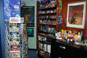 Office bookshelf with lots of toys and comics
